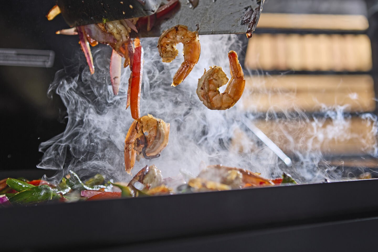 Prawn stir fry being cooked on a Weber Slate Premium Griddle