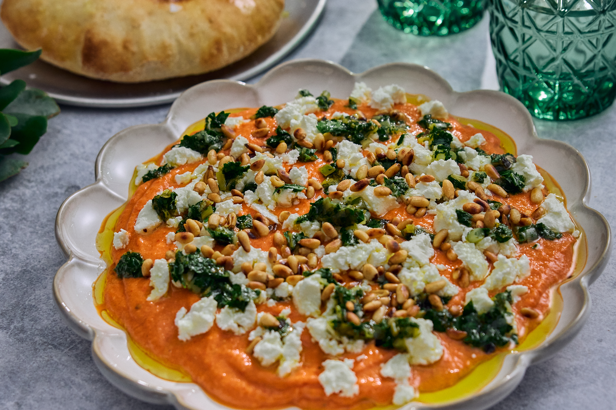 Puffy breads served with charred capsicum dip, feta, pine nuts and herbs
