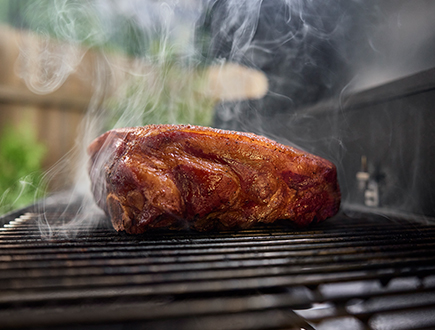 Pork butt smoking on the grill