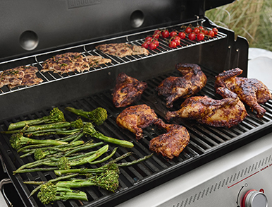 Turkey crowns and skewers cooking inside the Genesis grill