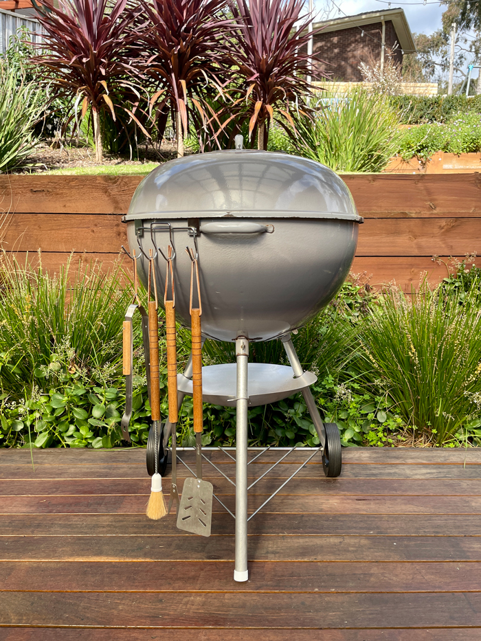 1963 Grey Plainsman Weber kettle with vintage tools hanging alongside