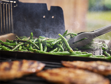 Green beans being tossed on the flat hotplate