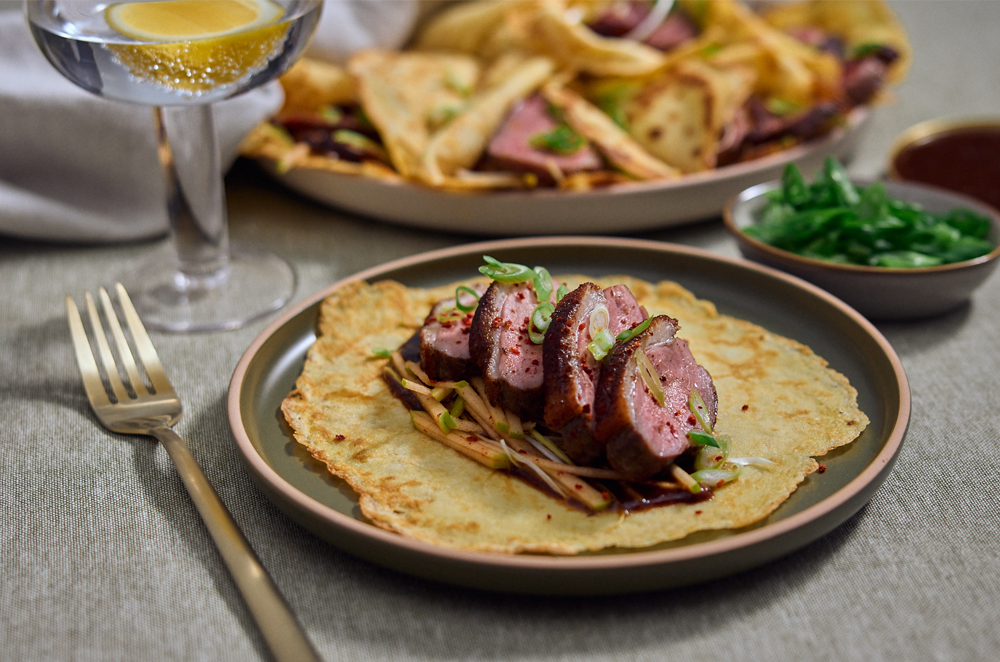 Peking duck inspired pancakes with sliced duck and fresh spring onion