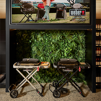 Customer viewing a Weber barbecue in store