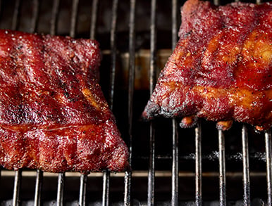 Racks of ribs smoking on the grill