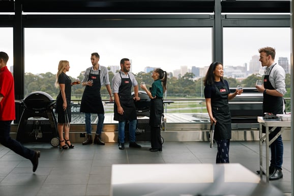 Grill Academy hosts preparing a tray of food