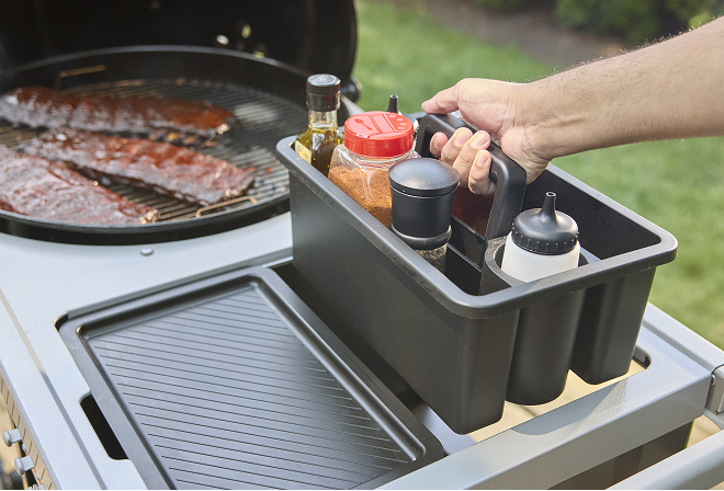 Weber Performer charcoal barbecue with Weber Works storage system holding tools and accessories neatly organised and within reach.