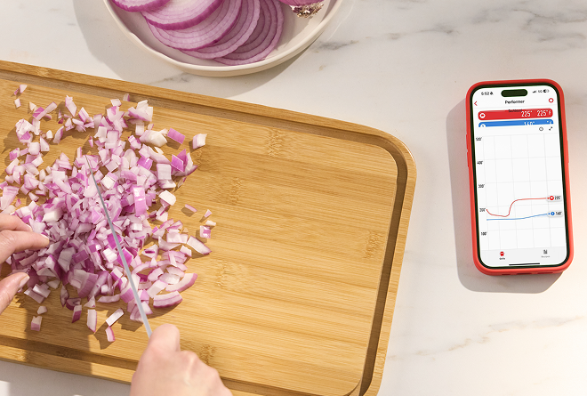 L&oslash;k som skj&aelig;res p&aring; en fj&oslash;l med en mobiltelefon som viser varsler fra Weber Connect-appen