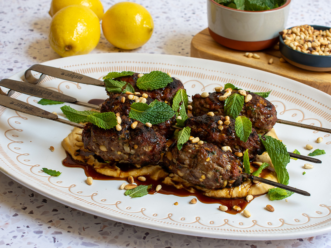  Lamb Kofta stuffed with Feta served on Hummus with Pomegranate Drizzle

